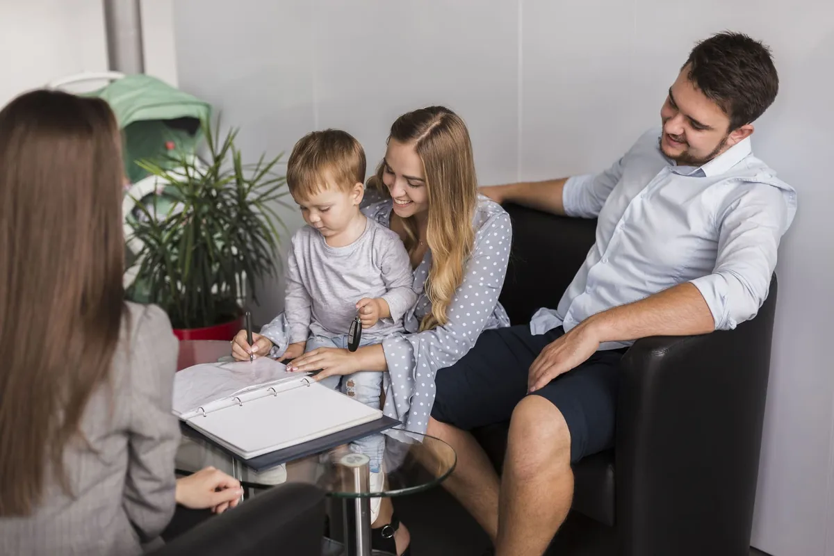 Family gathered around a table looking at their Estate Plan from Wills & Trust
